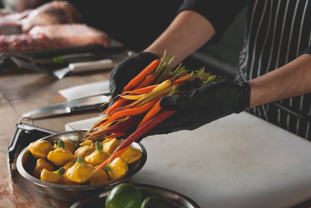 Chef Holding a Handful of Multi-Colored Carrots